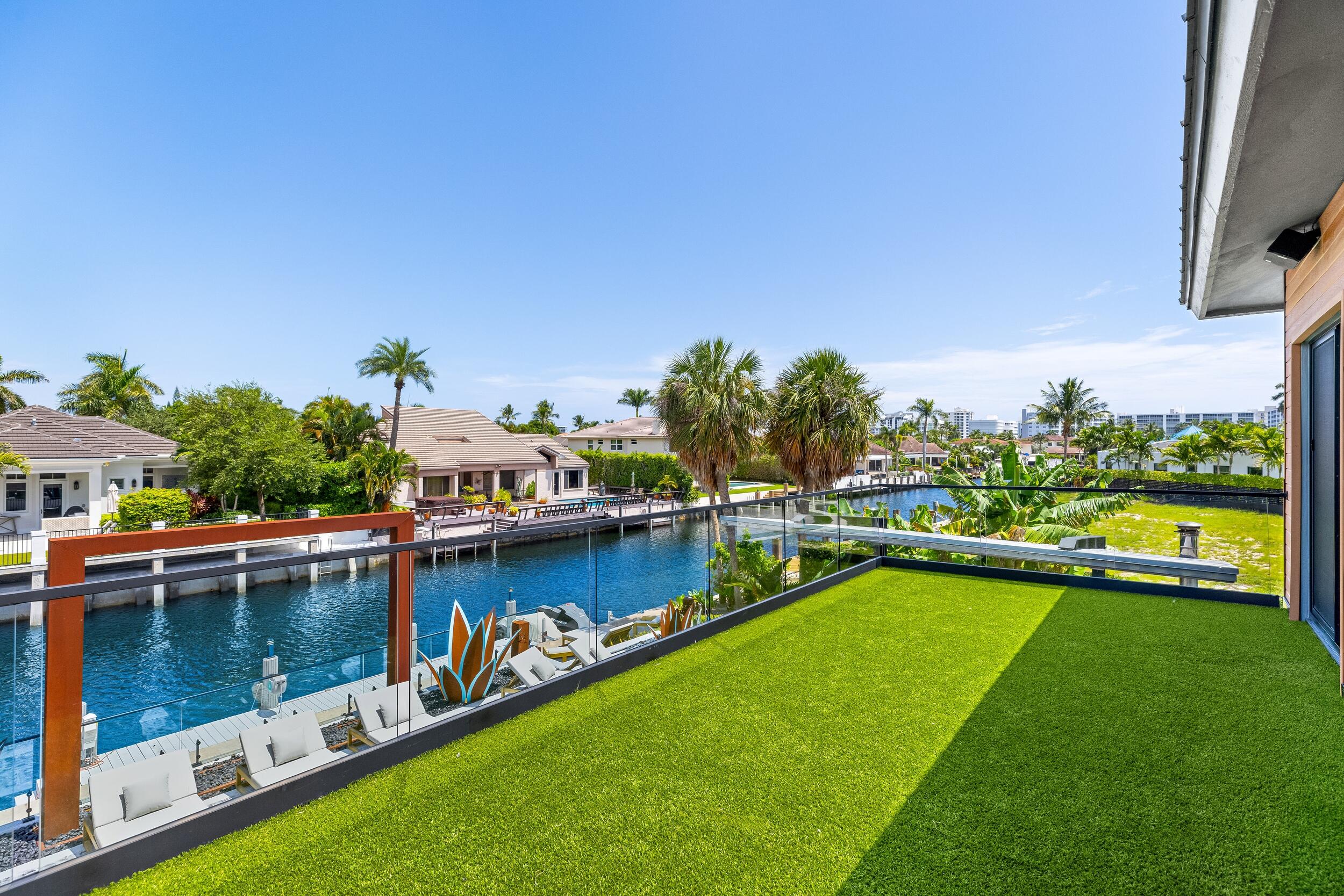 839 Northeast Bay Isle Drive Boca Raton, FL 33487 - Photo 56 of 103 a view of a lake with a house swimming pool and outdoor space