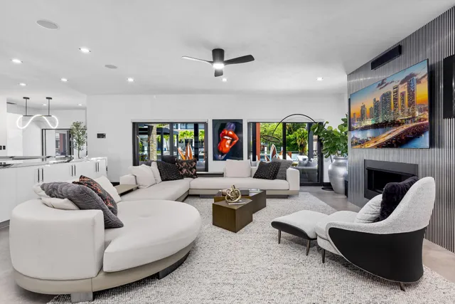 a view of a patio with dining table and chairs with a barbeque grill and couches