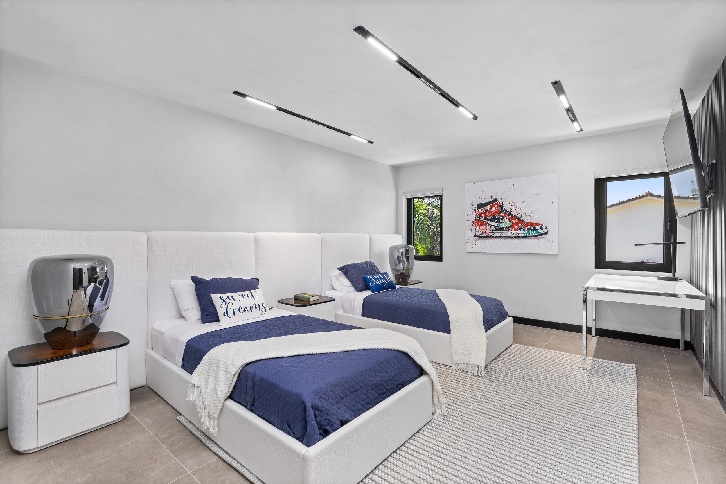 839 Northeast Bay Isle Drive Boca Raton, FL 33487 - Photo 75 of 103 a bedroom with two beds and painted walls