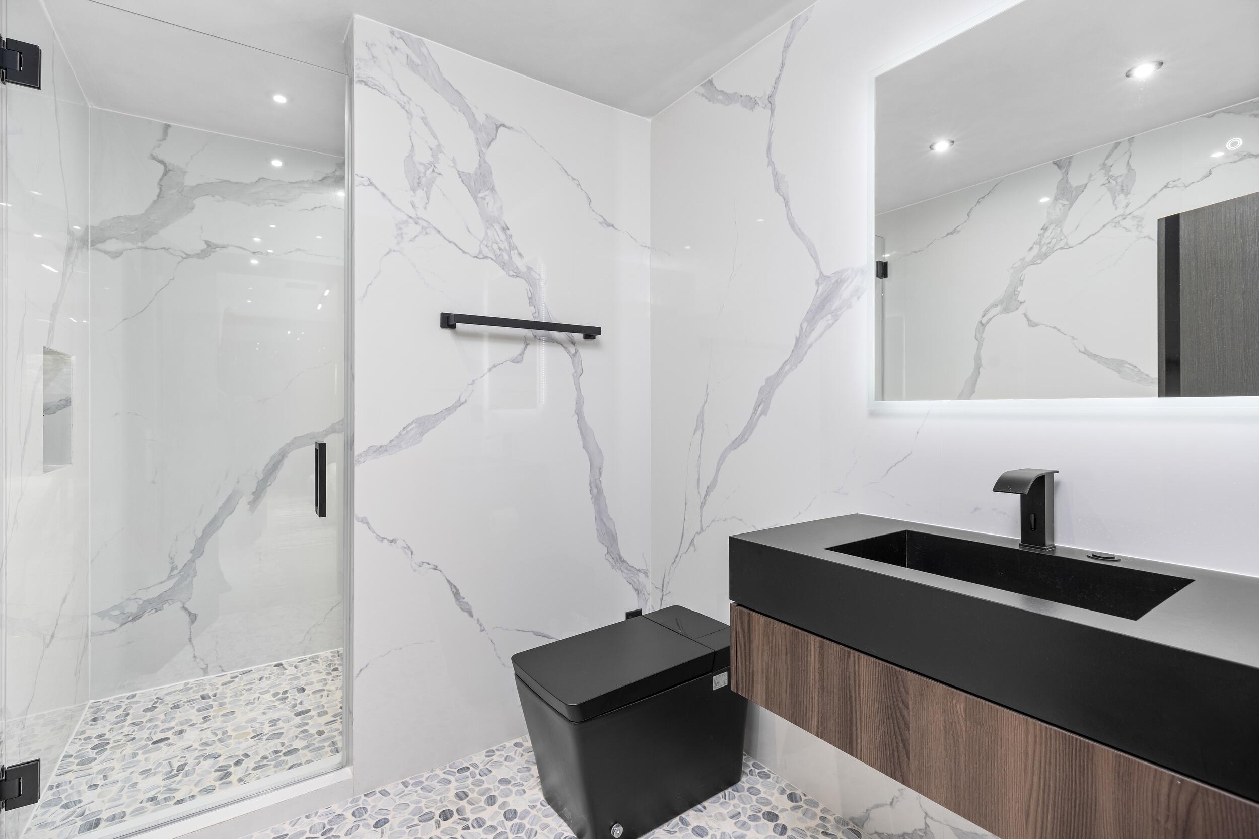 839 Northeast Bay Isle Drive Boca Raton, FL 33487 - Photo 81 of 103 a bathroom with a sink and a mirror