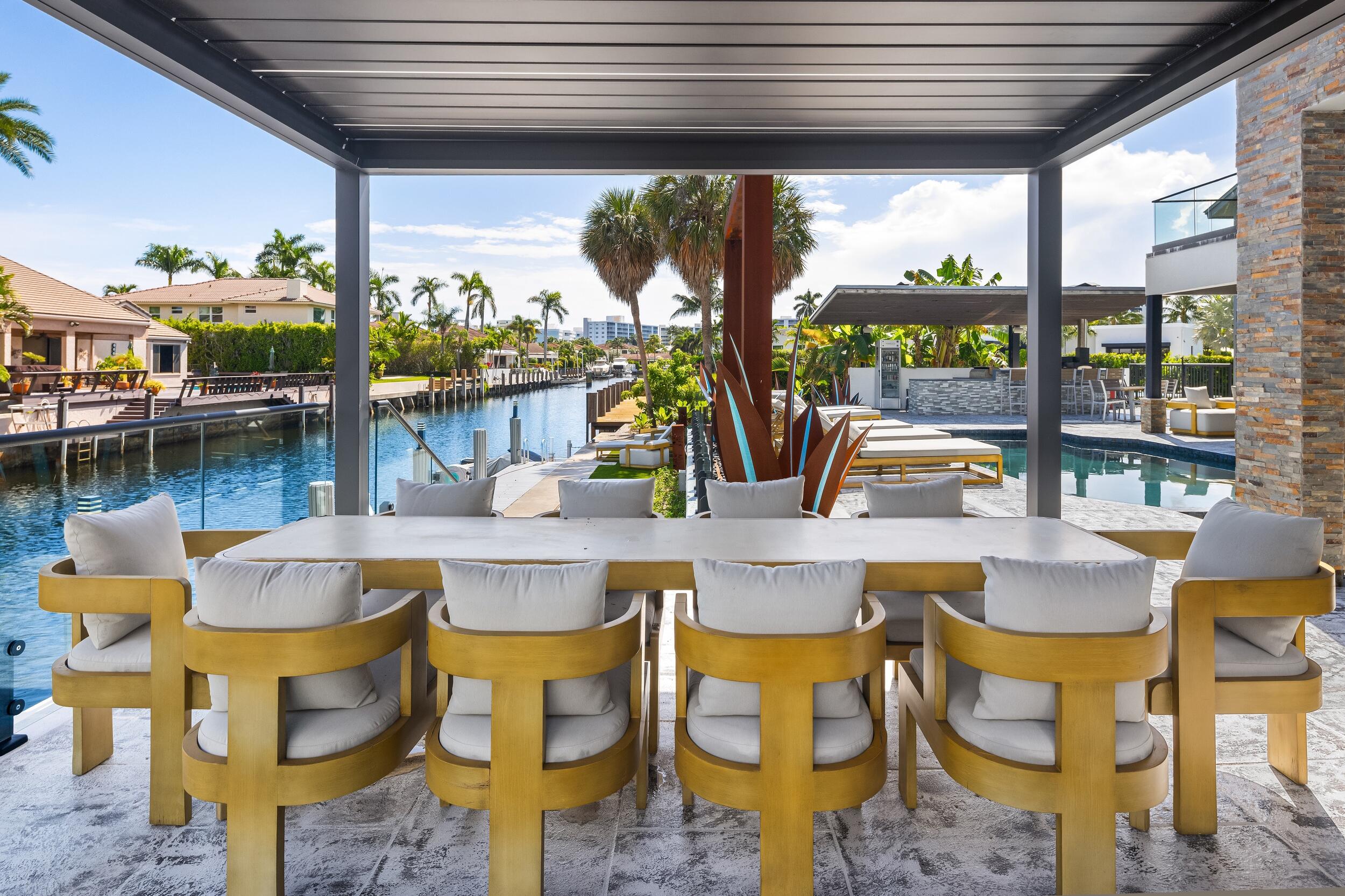 839 Northeast Bay Isle Drive Boca Raton, FL 33487 - Photo 85 of 103 a view of an outdoor dining space with a table and chairs