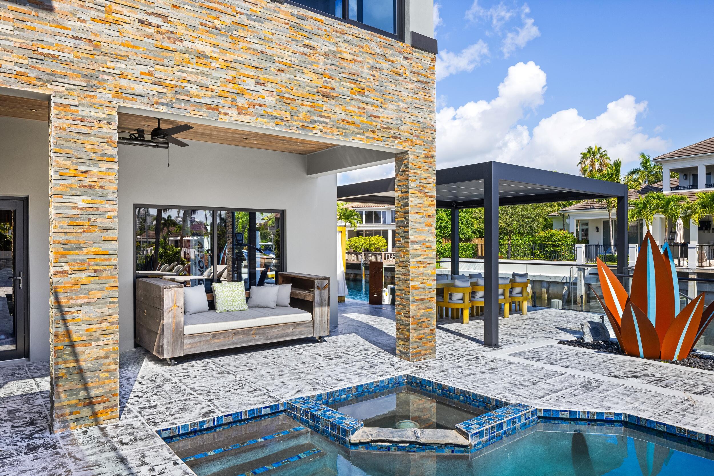 839 Northeast Bay Isle Drive Boca Raton, FL 33487 - Photo 92 of 103 a view of a house with backyard porch and furniture
