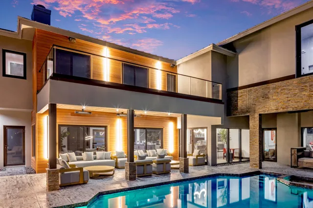a living room with patio furniture and a floor to ceiling window