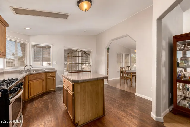 a kitchen with sink stove and cabinets
