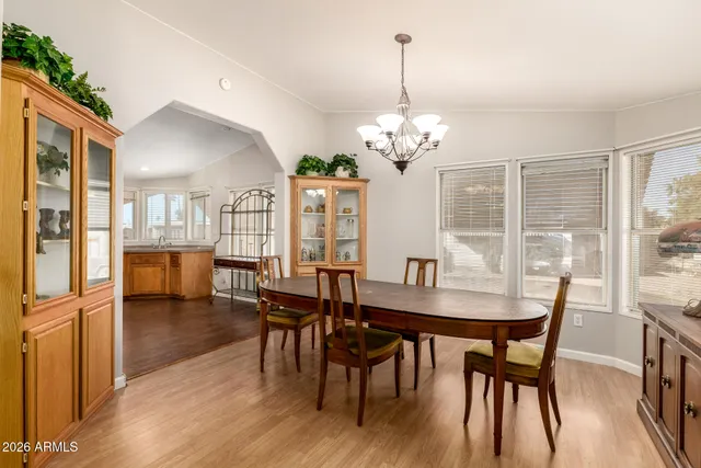 a view of a dining room with furniture wooden floor and chandelier
