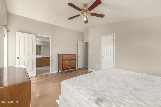 a spacious bedroom with a bed and a chandelier