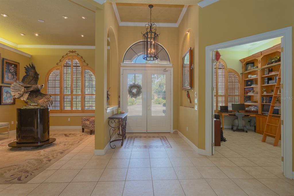 1640 Southeast 91st Place Ocala, FL 34480 - Photo 14 of 66 a view of a hallway with wooden floor and furniture