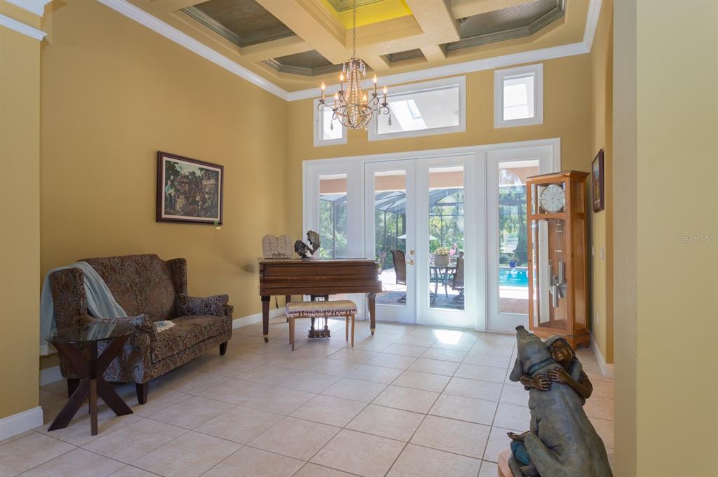 1640 Southeast 91st Place Ocala, FL 34480 - Photo 16 of 66 a living room with furniture and a floor to ceiling window