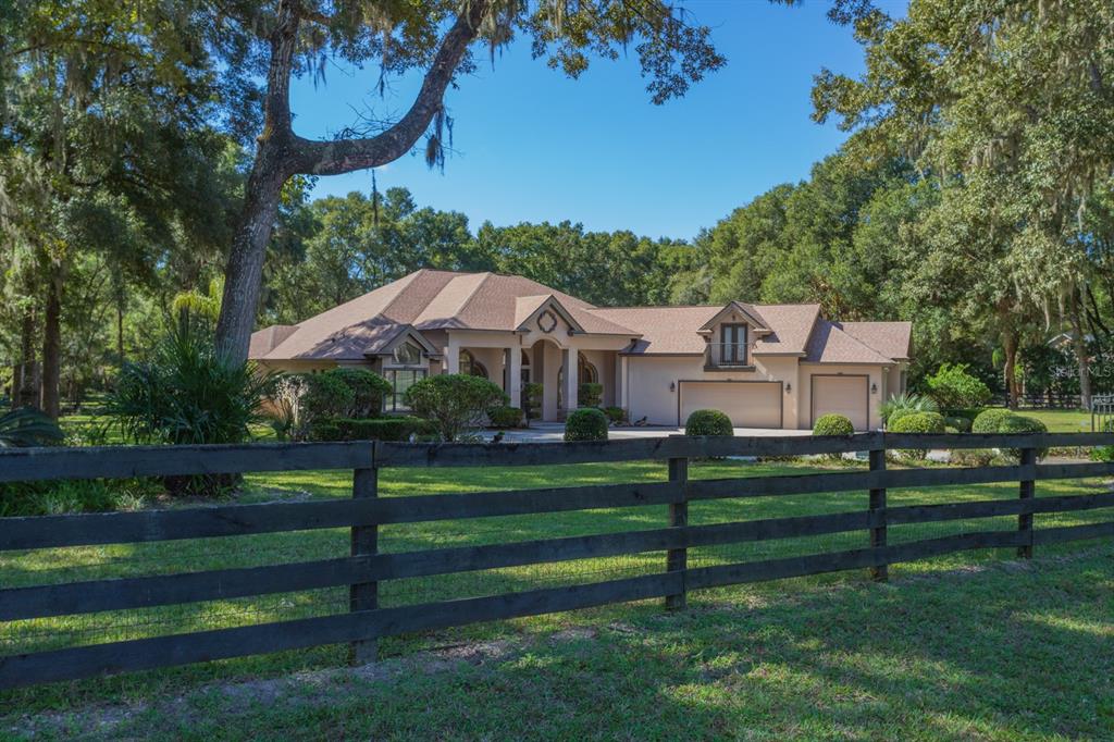1640 Southeast 91st Place Ocala, FL 34480 - Photo 2 of 66 a front view of a house with a yard