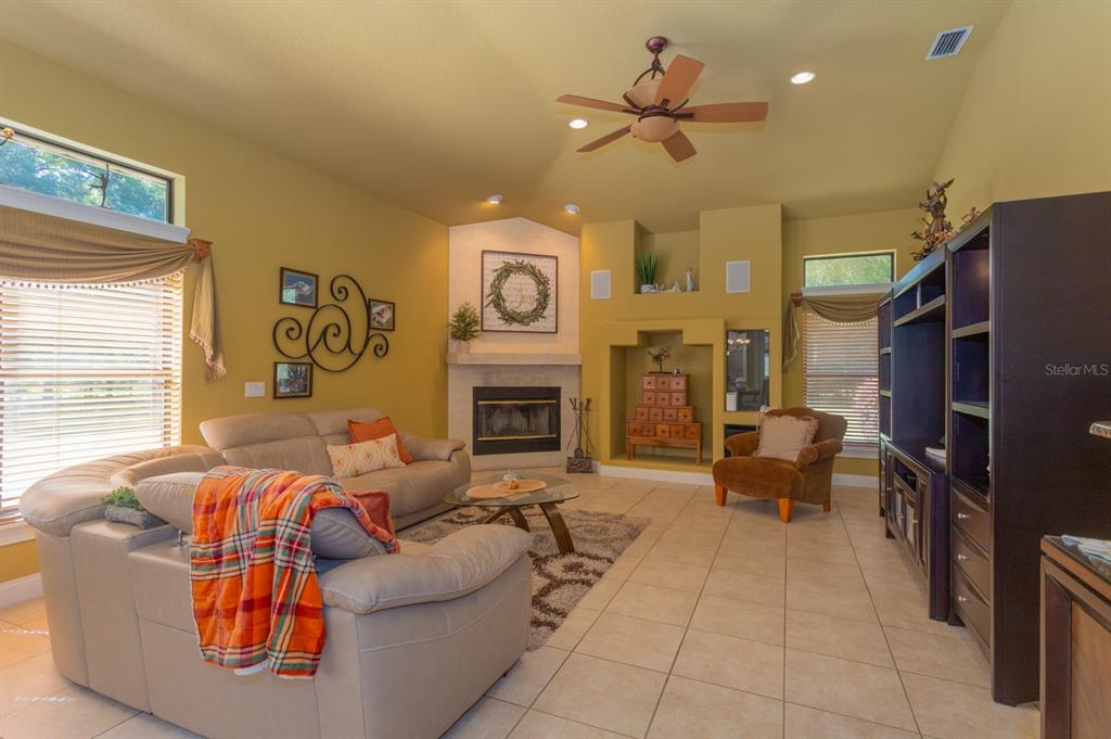 1640 Southeast 91st Place Ocala, FL 34480 - Photo 32 of 66 a living room with fireplace furniture and a large window