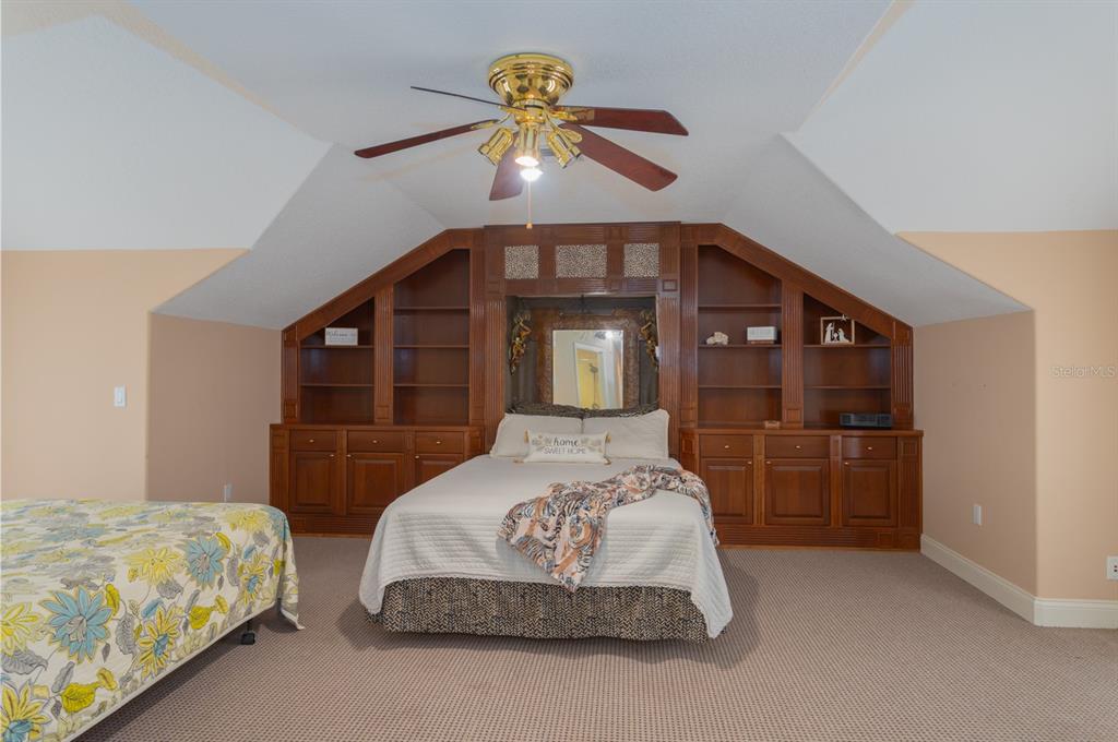 1640 Southeast 91st Place Ocala, FL 34480 - Photo 40 of 66 a bedroom with a bed and a chandelier