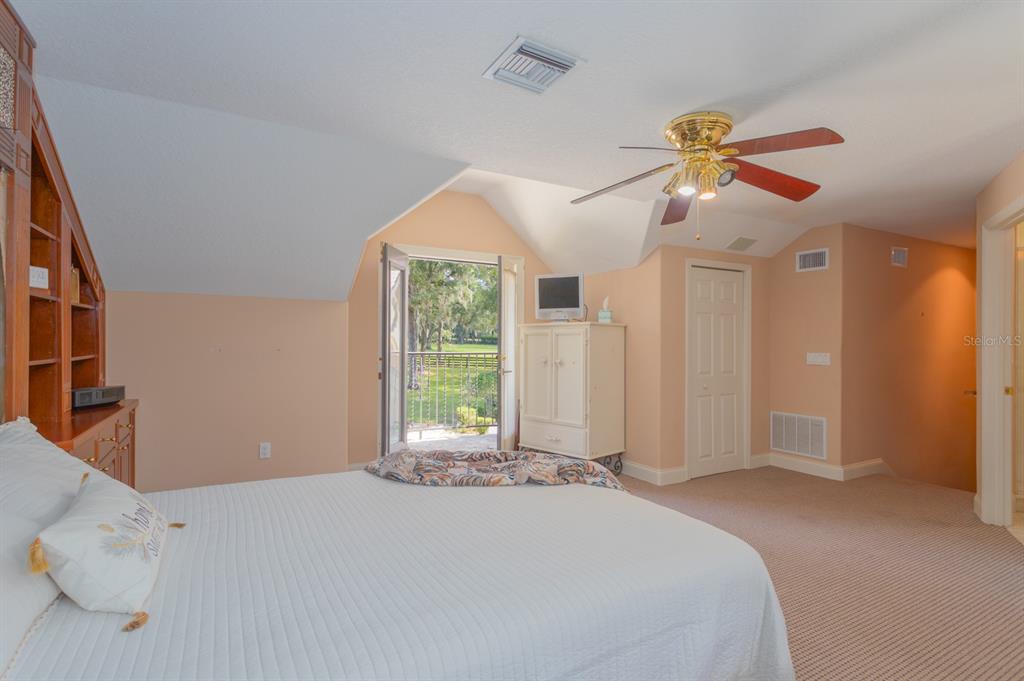 1640 Southeast 91st Place Ocala, FL 34480 - Photo 41 of 66 a bedroom with a bed and a chandelier