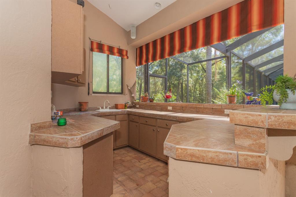 1640 Southeast 91st Place Ocala, FL 34480 - Photo 44 of 66 a kitchen with a sink and a stove top oven