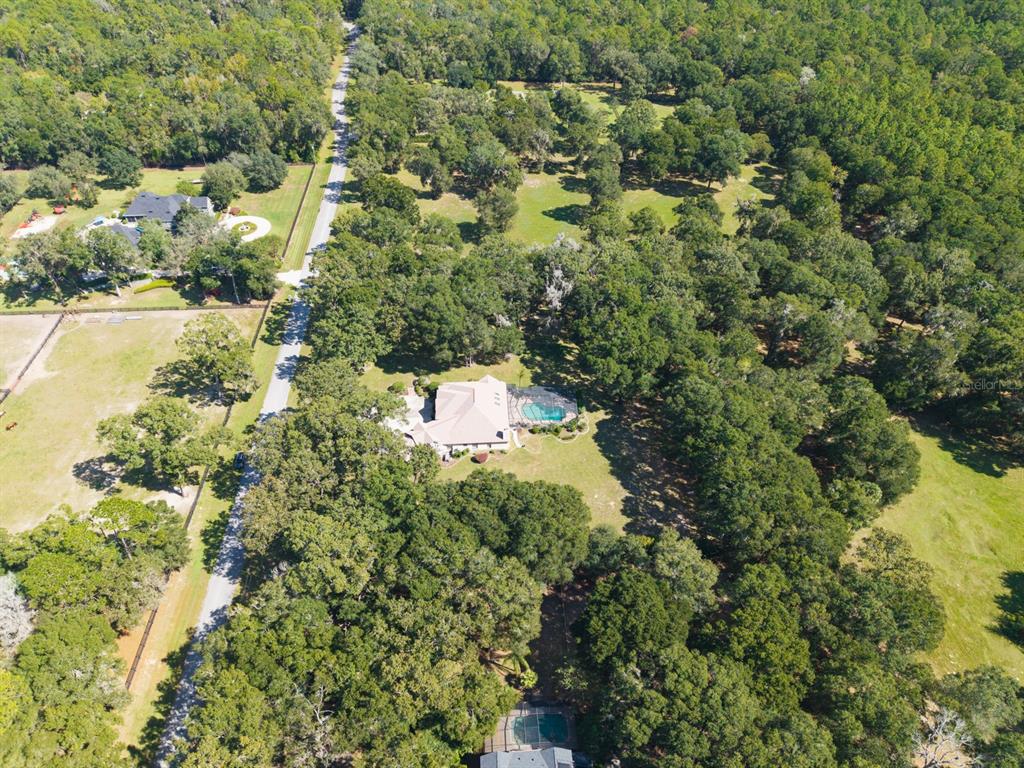 1640 Southeast 91st Place Ocala, FL 34480 - Photo 56 of 66 an aerial view of a house with a yard and swimming pool