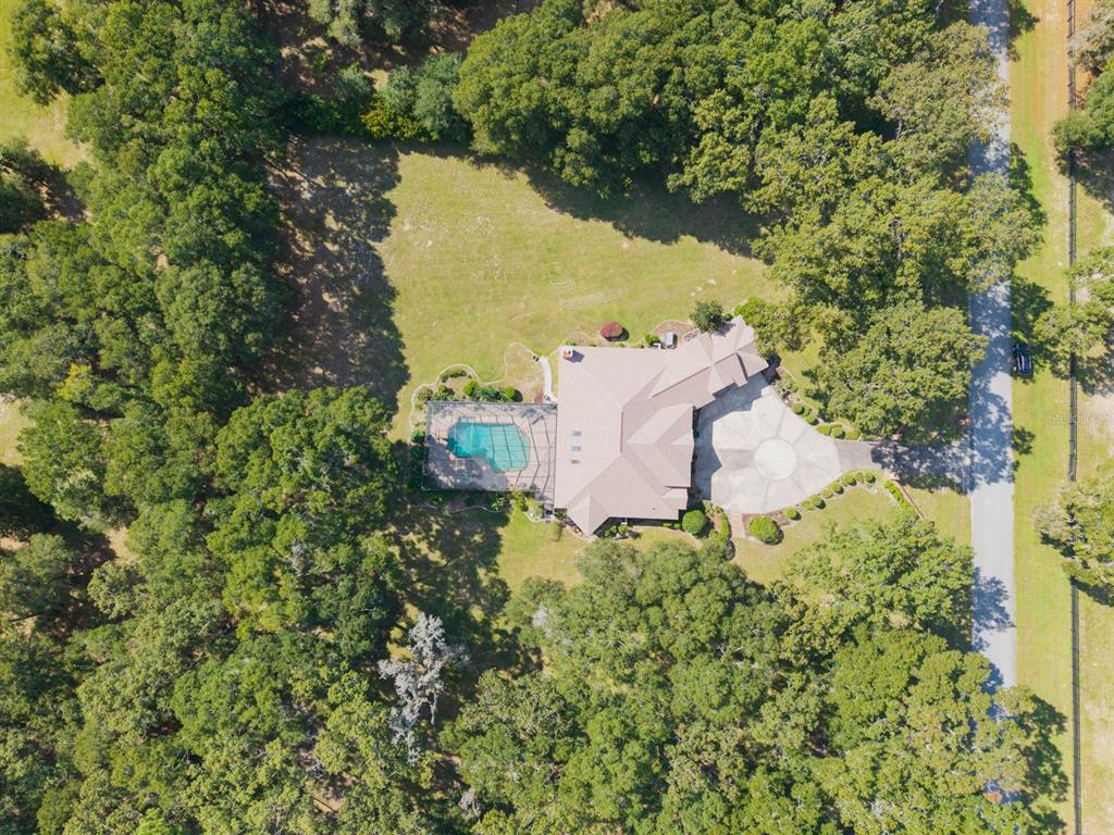 1640 Southeast 91st Place Ocala, FL 34480 - Photo 58 of 66 an aerial view of a house with a yard and lake view