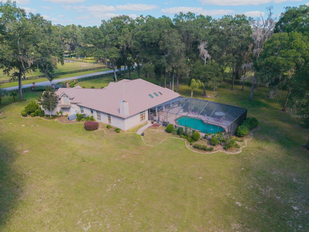 1640 Southeast 91st Place Ocala, FL 34480 - Photo 60 of 66 an aerial view of a house with pool and a yard