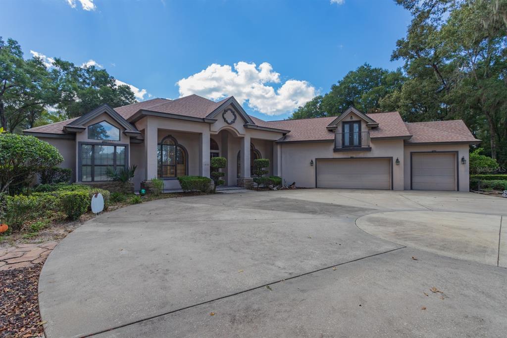 1640 Southeast 91st Place Ocala, FL 34480 - Photo 8 of 66 a front view of a house with a yard and garage