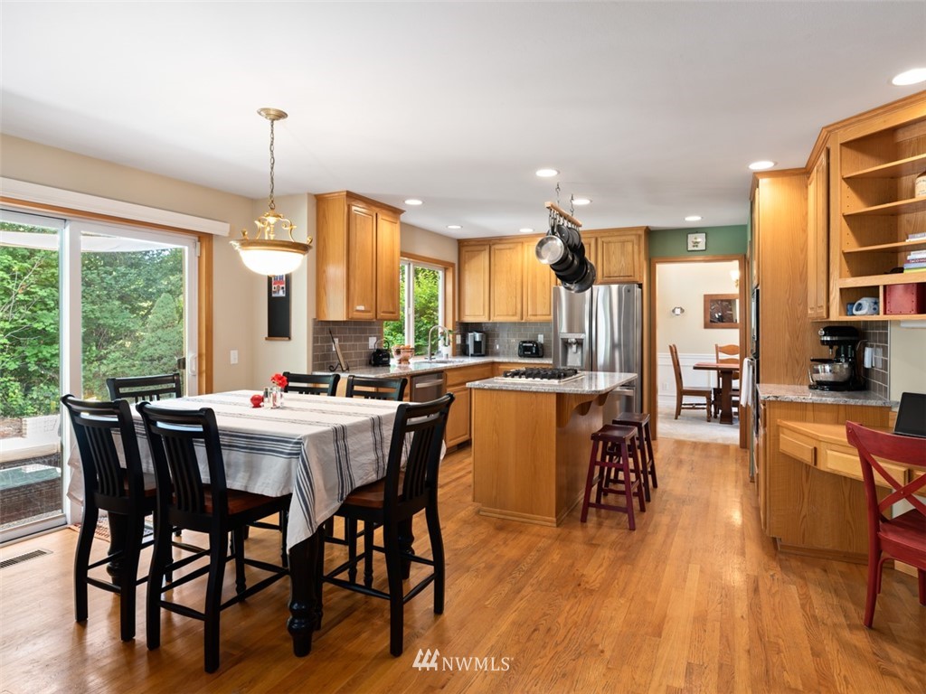 425 172nd Place Southeast Bothell, WA 98012 - Photo 14 of 32 a dining hall with stainless steel appliances granite countertop a table chairs and a view of living room