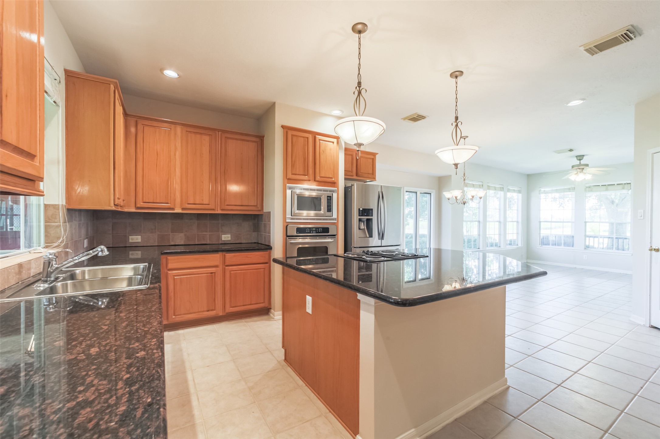 4903 Bowser Road Fulshear, TX 77441 - Photo 15 of 50 View of Kitchen with Breakfast area and Sunroom in background