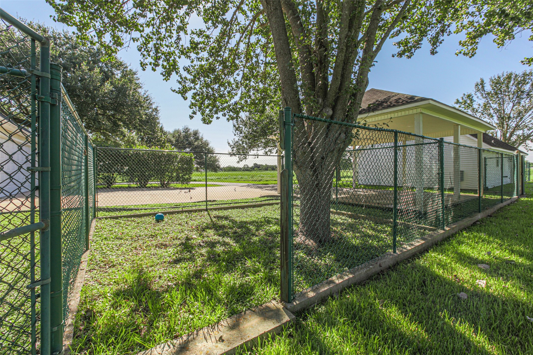 4903 Bowser Road Fulshear, TX 77441 - Photo 48 of 50 One of several chain-link fenced areas in the back yard for pets, and notice the concrete base to prevent digging