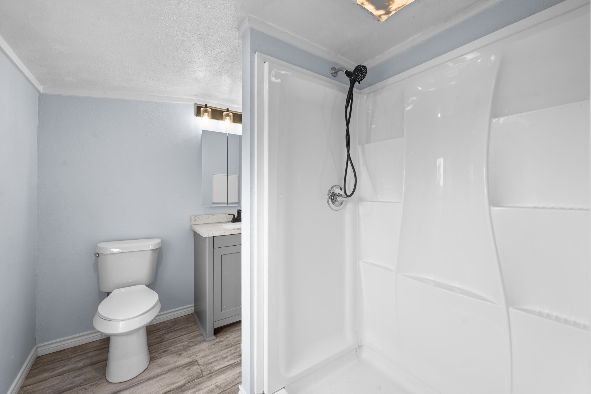2534 Bastrop Angleton, TX 77515 - Photo 23 of 50 Updated primary bathroom featuring a walk-in shower with modern fixtures, updated vanity, and fresh neutral finishes throughout. Clean lines and functional design create a bright, low-maintenance space with everyday comfort in mind.