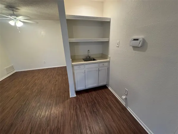 a room with wooden floors and a sink