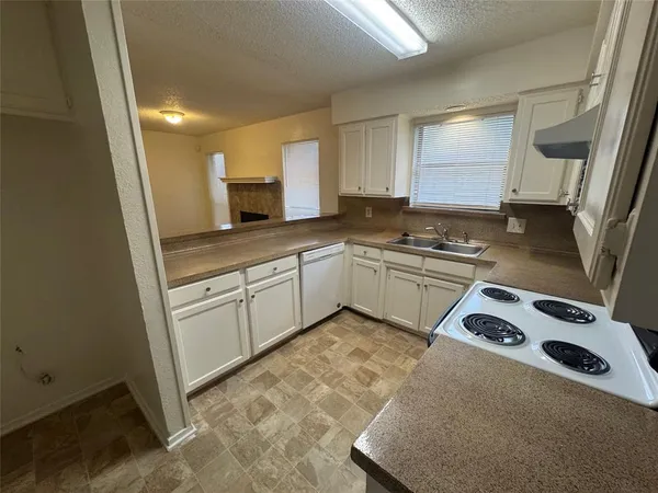 a kitchen with a sink stove and cabinets