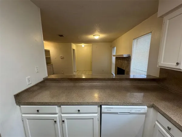 a view of a kitchen with a sink and dishwasher