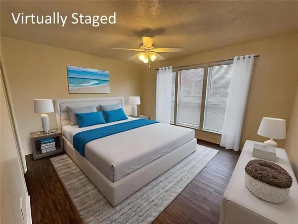 a bedroom with a large bed and a large window