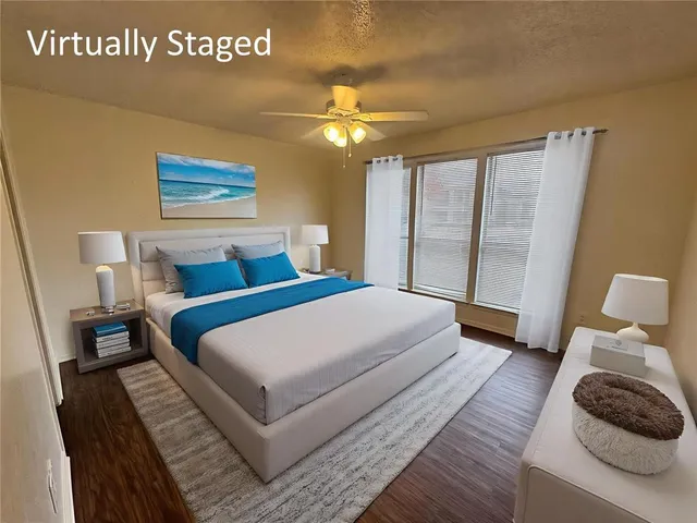 a bedroom with a large bed and a large window