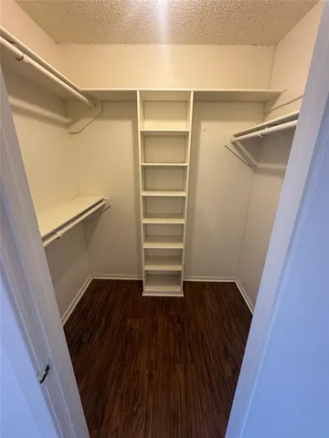 a view of walk in closet with empty racks
