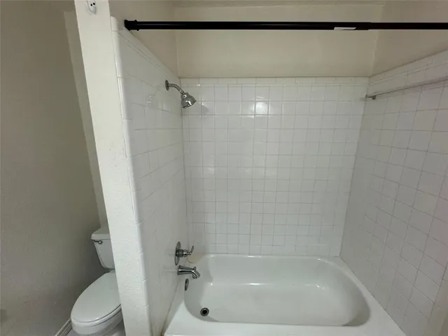 a bathroom with a shower and a toilet