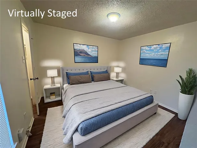 a bedroom with a bed and a potted plant