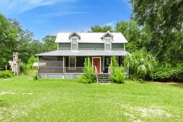 a front view of house with yard and green space