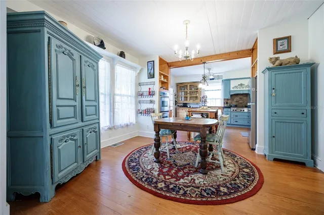 a view of a dining room with furniture window and wooden floor