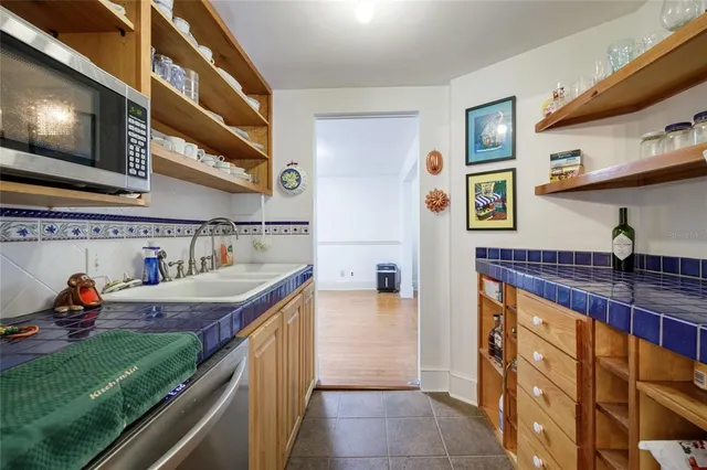 a living room with furniture a fireplace and wooden floor