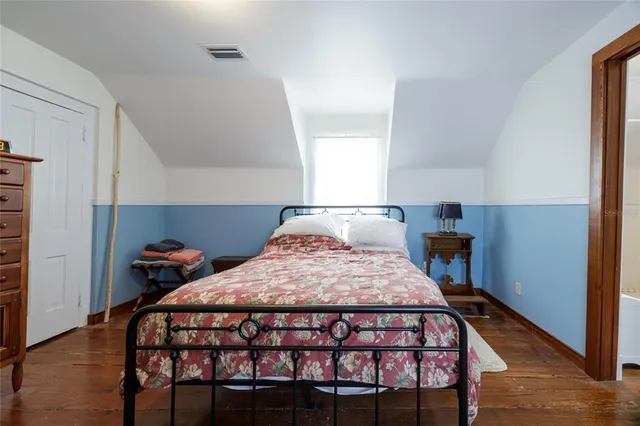 a bedroom with a bed and window