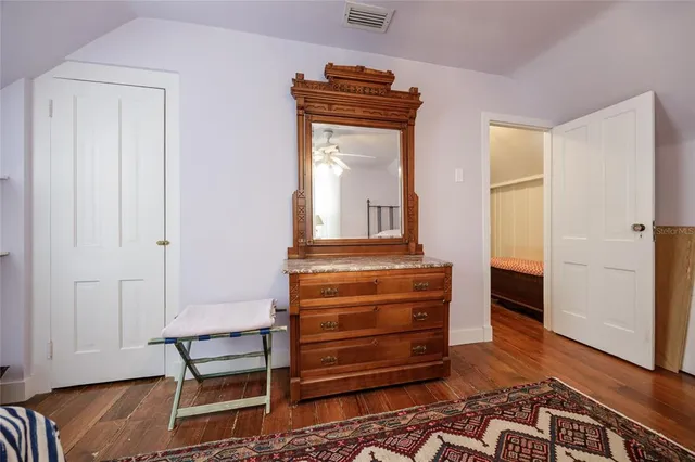 a bedroom with a bed and chair