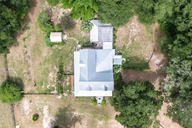 an aerial view of a house with a yard