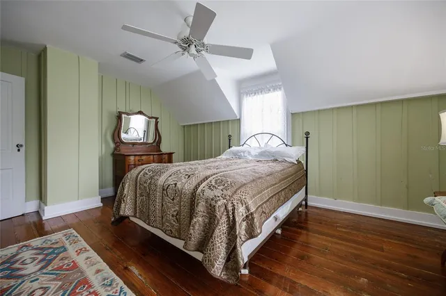 a bedroom with a large bed and a window