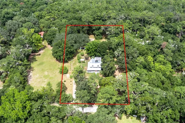 an aerial view of a houses with yard