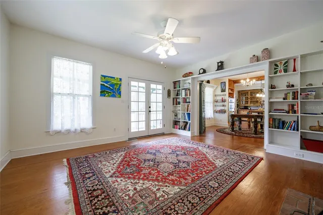 a living room with hard wood flooring and a rug