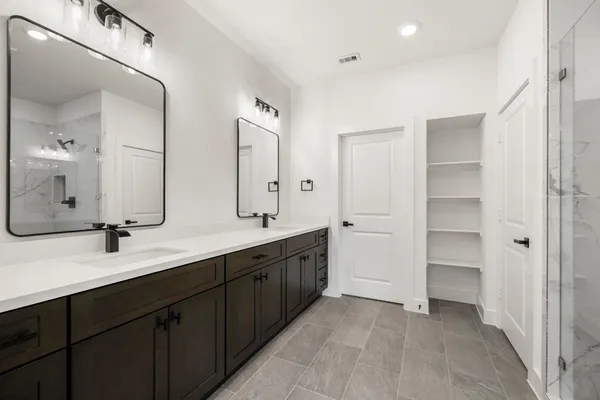 a spacious bathroom with a double vanity sink mirror and double