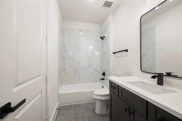 a bathroom with a sink toilet a bathtub and vanity