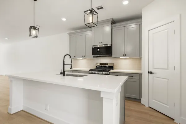 a kitchen with stainless steel appliances a sink stove and refrigerator