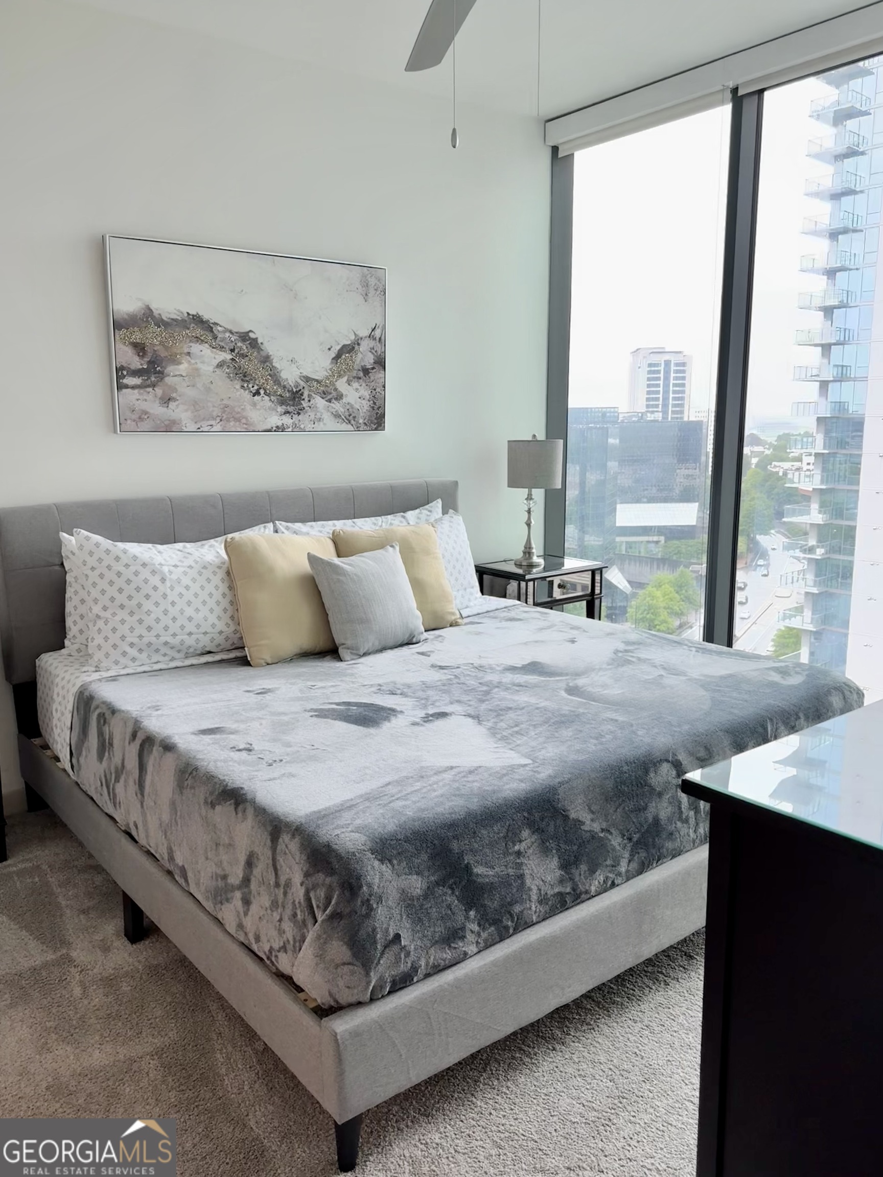 3382 Peachtree Road, Unit S12 Atlanta, GA 30326 - Photo 14 of 47 a bedroom with a large bed and a painting on the wall