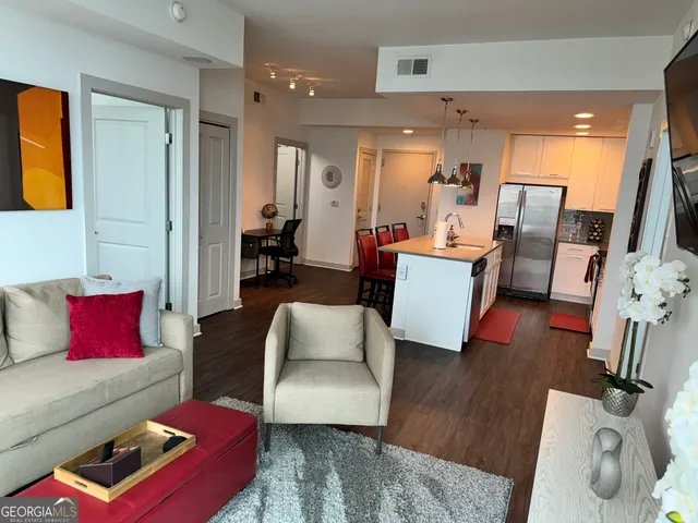 a living room with furniture and wooden floor