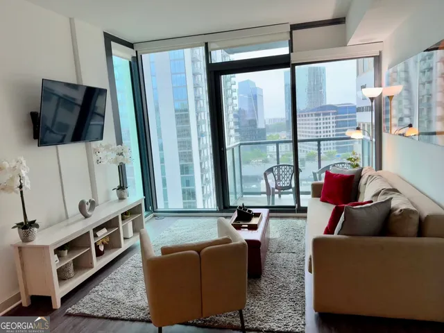 a living room with furniture and a flat screen tv