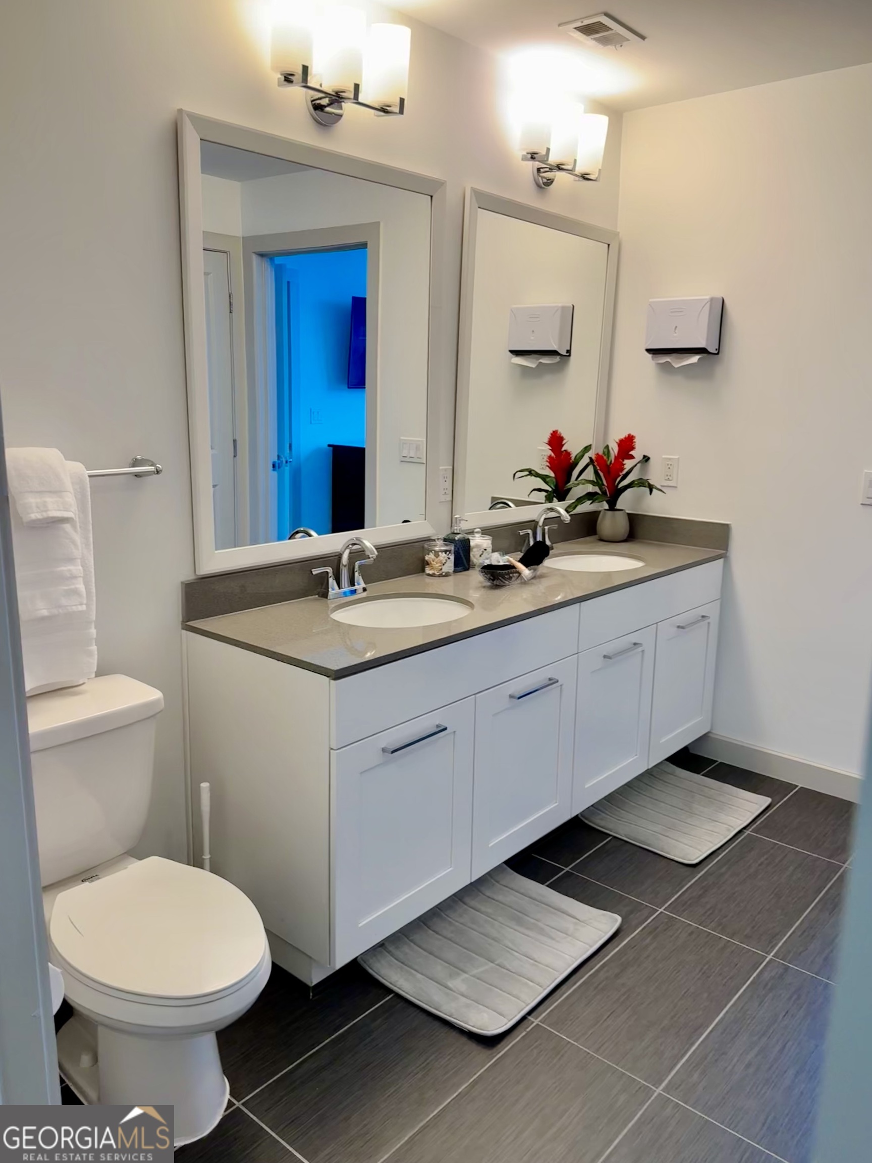 3382 Peachtree Road, Unit S12 Atlanta, GA 30326 - Photo 25 of 47 a bathroom with a toilet sink and mirror