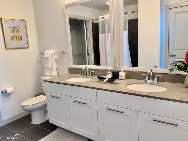 a bathroom with double sink and a mirror